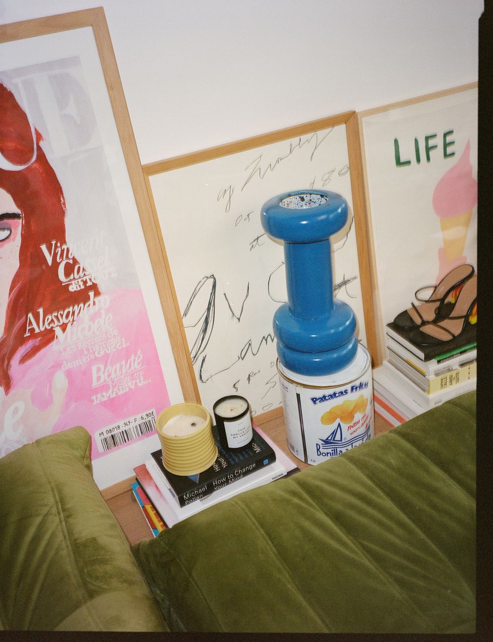 a blue bottle next to a book and a book on a bed