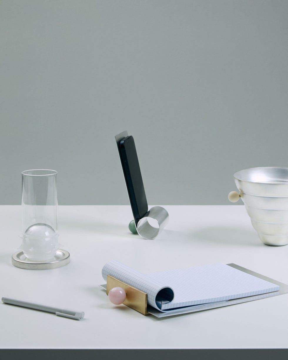 a paper pad and a phone holder on a desk