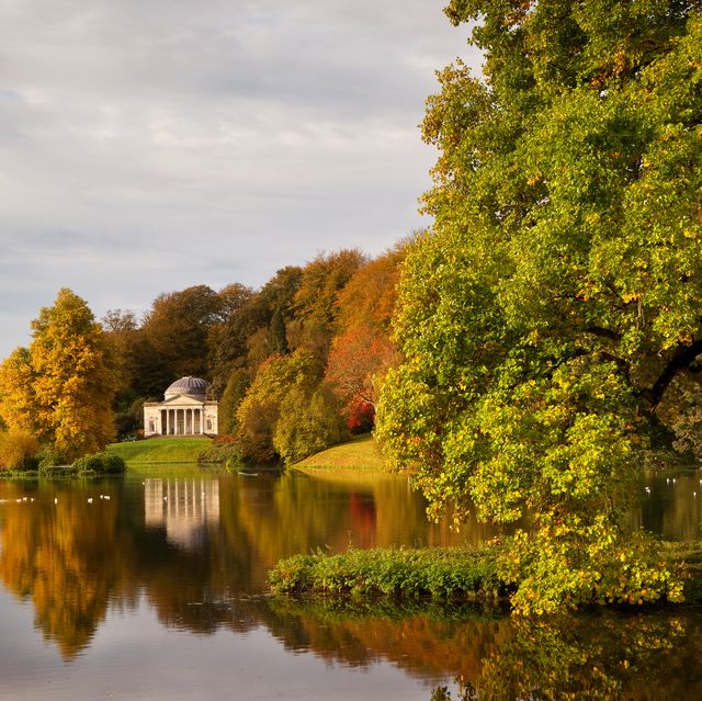 in autumn, a view across the lake to the pantheon at stourhead gardens, wiltshire, uk
