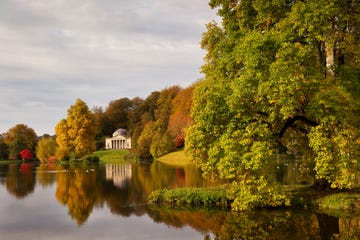 in autumn, a view across the lake to the pantheon at stourhead gardens, wiltshire, uk