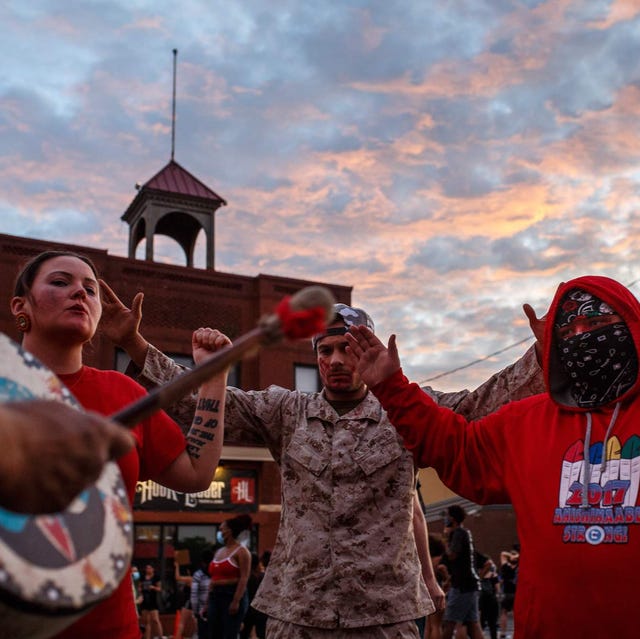 native americans pray to call for justice during a demonstration over the killing of george floyd by a policeman outside the third police precinct on may 27, 2020 in minneapolis, minnesota   demonstrators gathered on may 27 for a second night of protests over the killing in the us city of minneapolis of a handcuffed black man by a policeman who held him to the ground with a knee on his neck as dusk fell, police formed a human barricade around the third precinct, where the officers accused of killing george floyd worked before they were fired on tuesday photo by kerem yucel  afp photo by kerem yucelafp via getty images