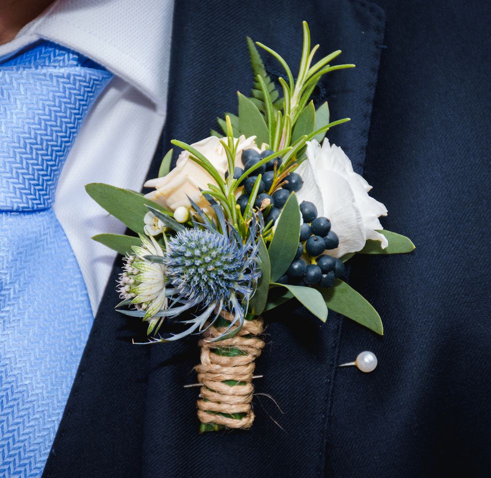 Natural flowers boutonhole in the pocket of the groom