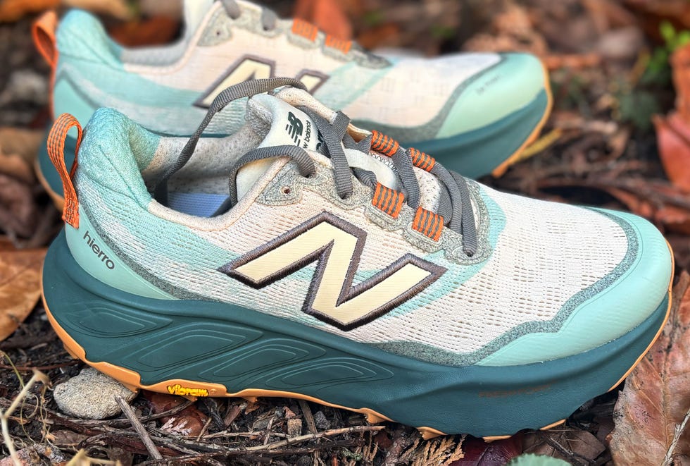 a pair of green and grey trail running shoes