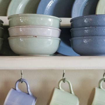 Crockery shelves with blue and green plates and cups