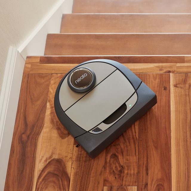 neato robot vacuum on top of stairs