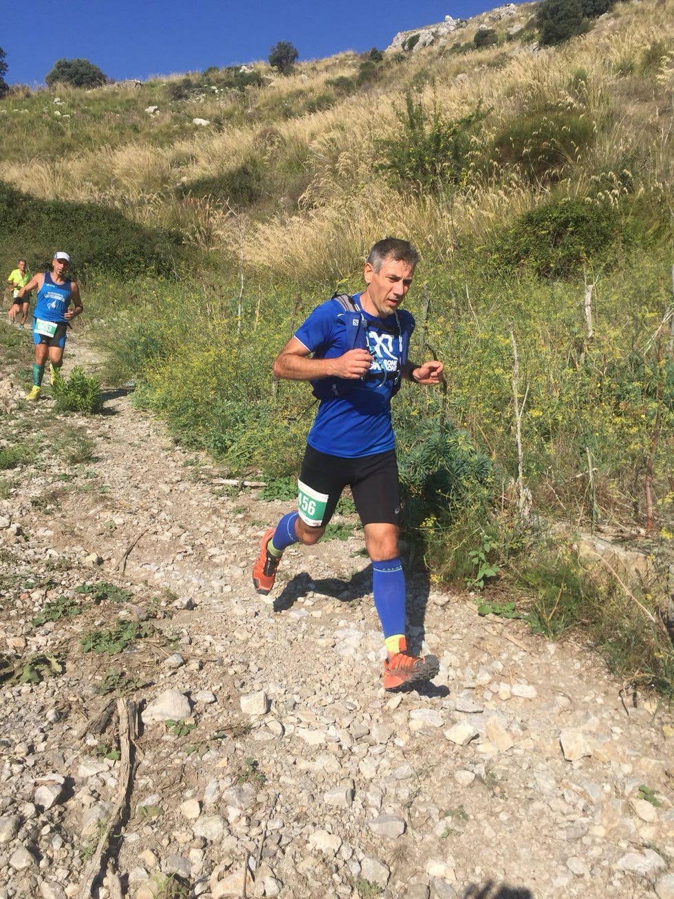 runners participating in a trail run event on a rocky path