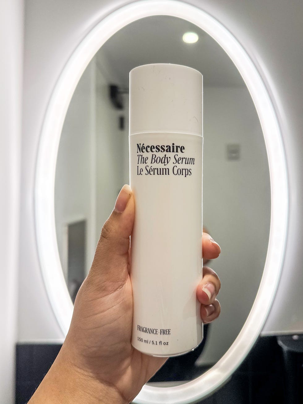 nicole holding up the necessaire the body serum container