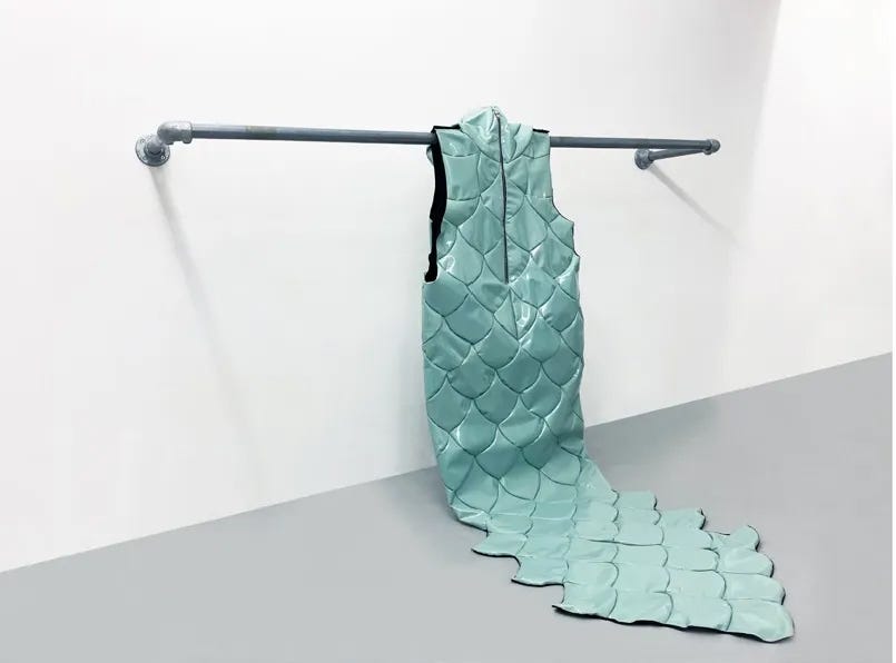 a unique dress hanging from a metal rail