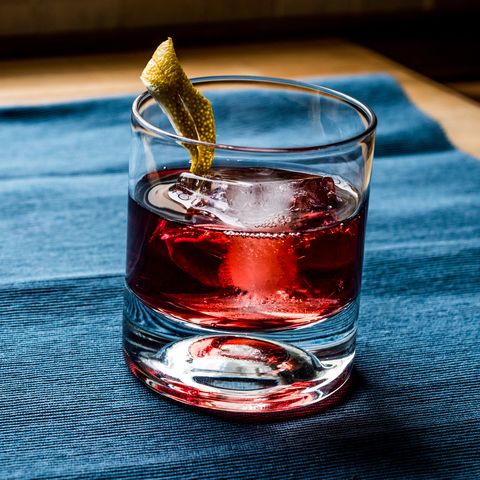 Negroni Cocktail with lemon peel and ice.