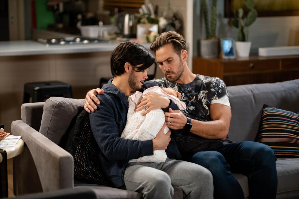 david tanaka and aaron brennan with the baby in neighbours