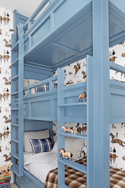 bedroom with stacked blue bunkbeds and horse wallpaper