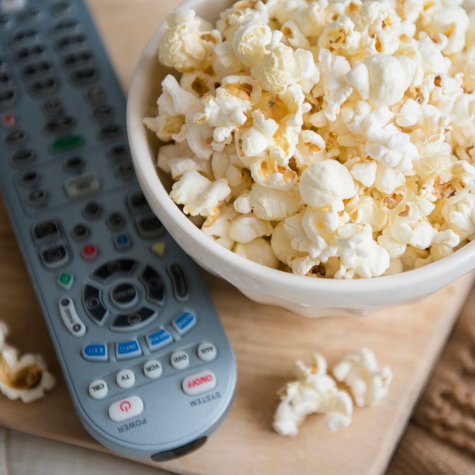 Self care with popcorn and remote control zoning out to tv or a movie with a popcorn is a valid form of self care