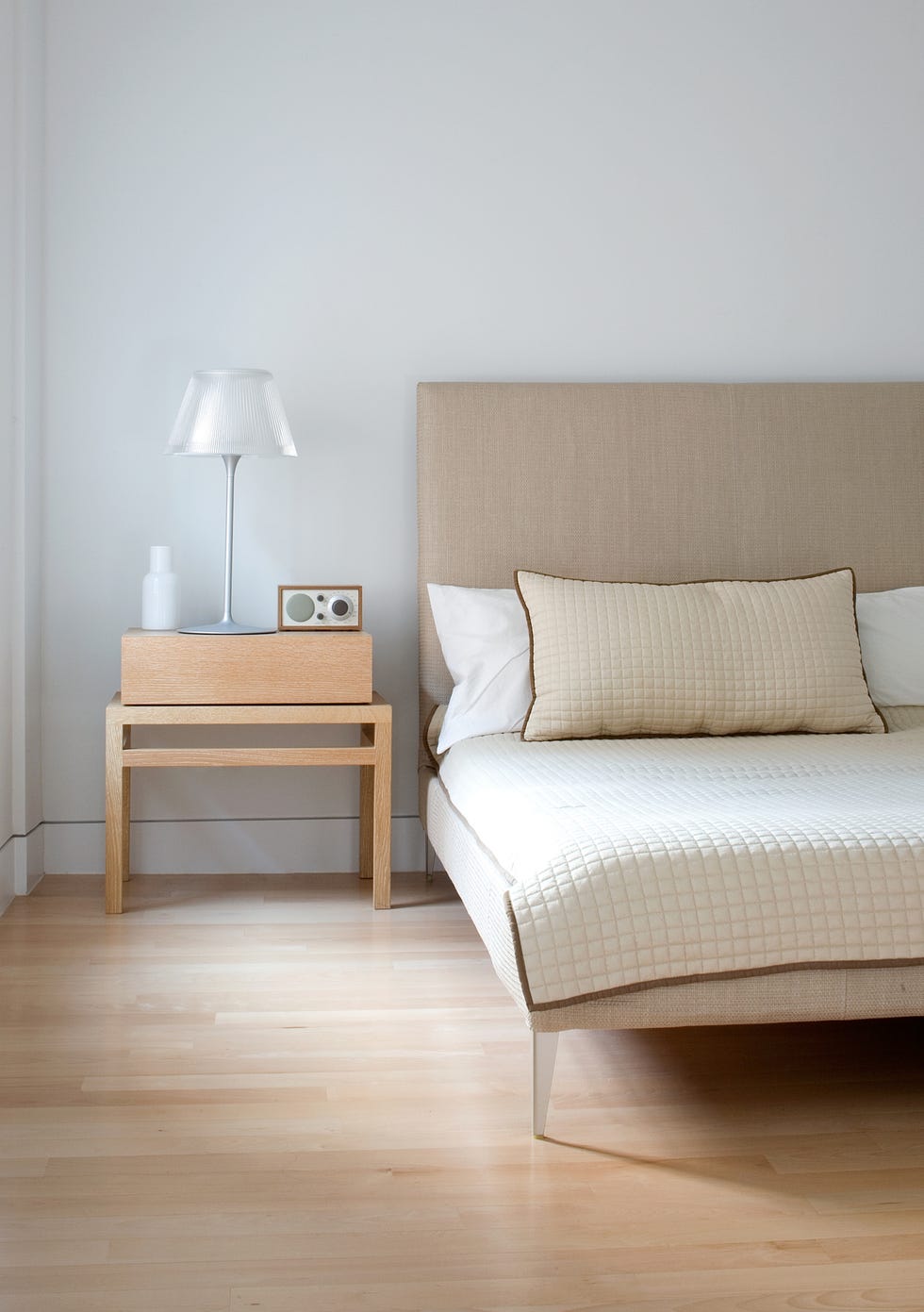 a section of a natural toned bedroom