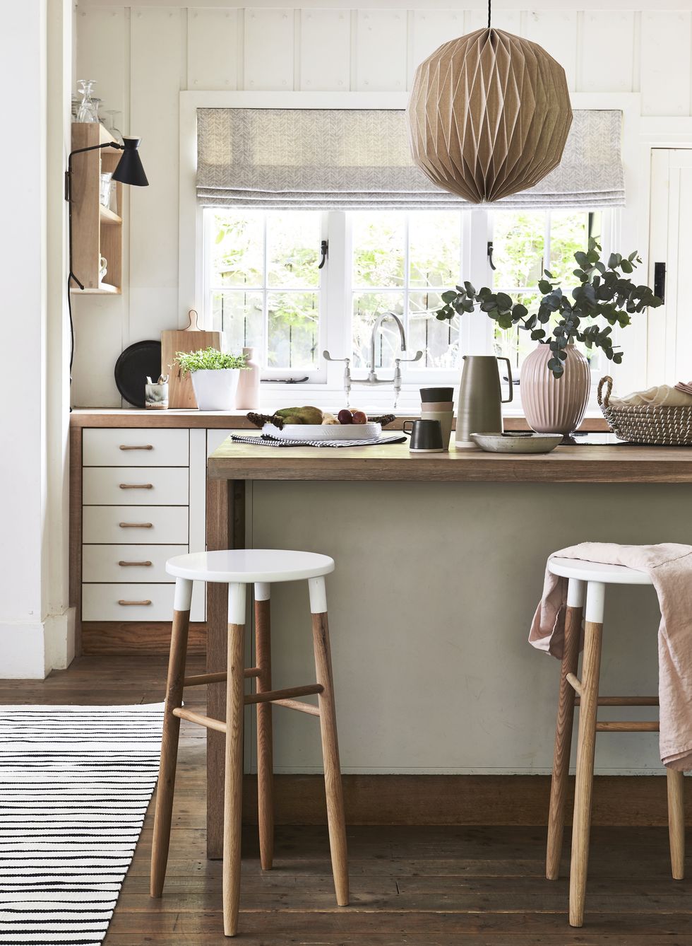 lagom, the swedish idea of having just the right amount, is captured in a perfect balance of rose tinted neutrals, wood and cosy texturesneutral and wood kitchen with kitchen counterwhite painted stool tops and drawer fronts add just enough contrast to this elegant scheme wooden pendant light