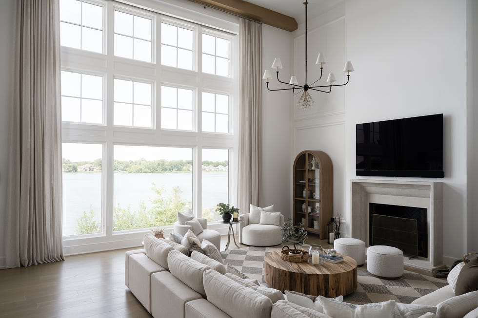 neutral living room with floor to ceiling windows