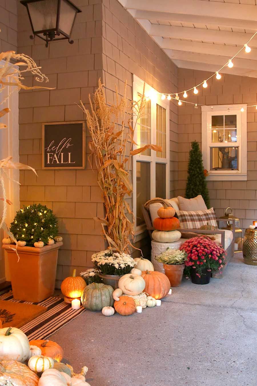 fall front porch decor with bistro lights and candles