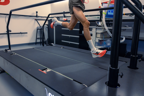 a person running on a treadmill in a shoe testing lab
