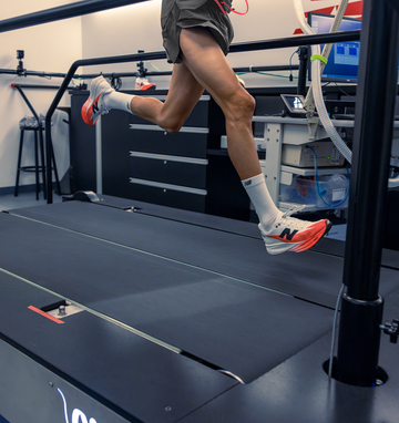 a person running on a treadmill in a shoe testing lab a person running on a treadmill in a shoe testing lab