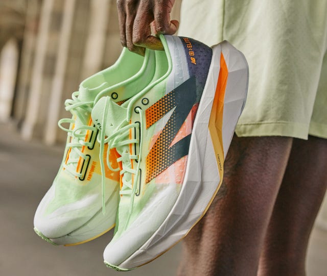 a person wearing a green and yellow shoe