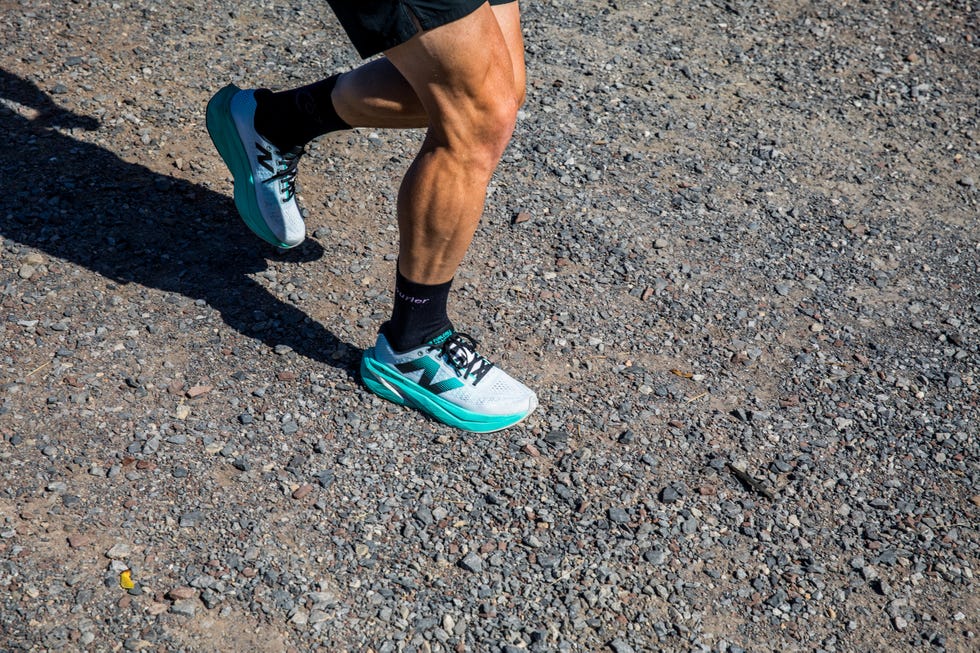 a person running on a gravel path