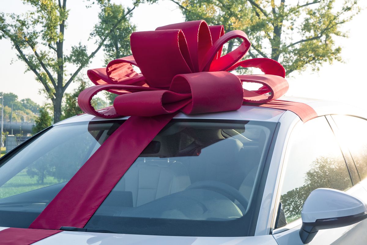 new car gift new white car with red gift ribbon