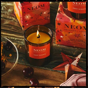 two christmas candles, one from neom and one from cowshed