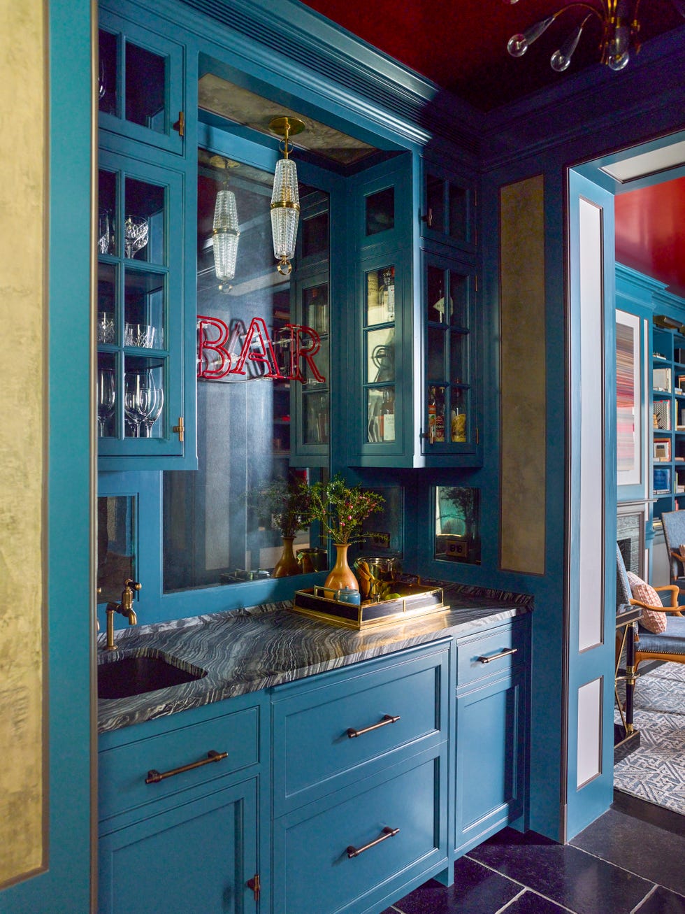 a blue bar with a marble countertop and sign that says bar