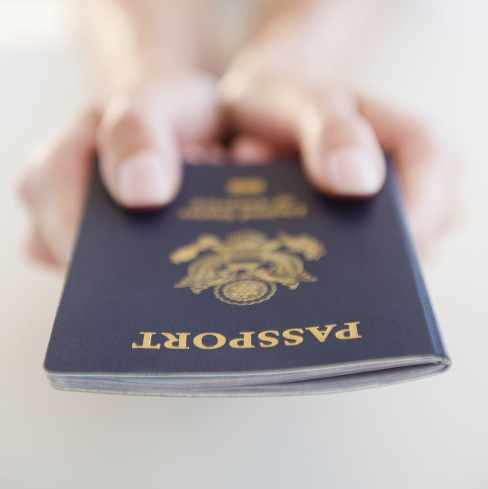 usa, new jersey, jersey city, close up view of woman's hands holding us passport