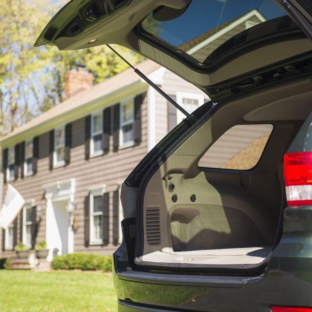 usa, new jersey, mendham, open car trunk in front of house