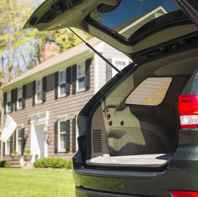 usa, new jersey, mendham, open car trunk in front of house