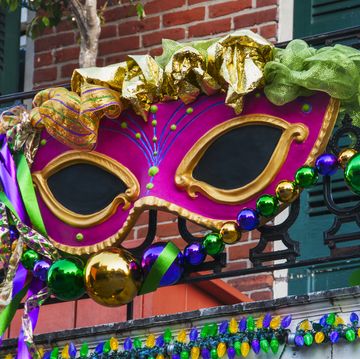 usa, new orleans, louisiana, mardi gras mask hanging on balcony's railing
