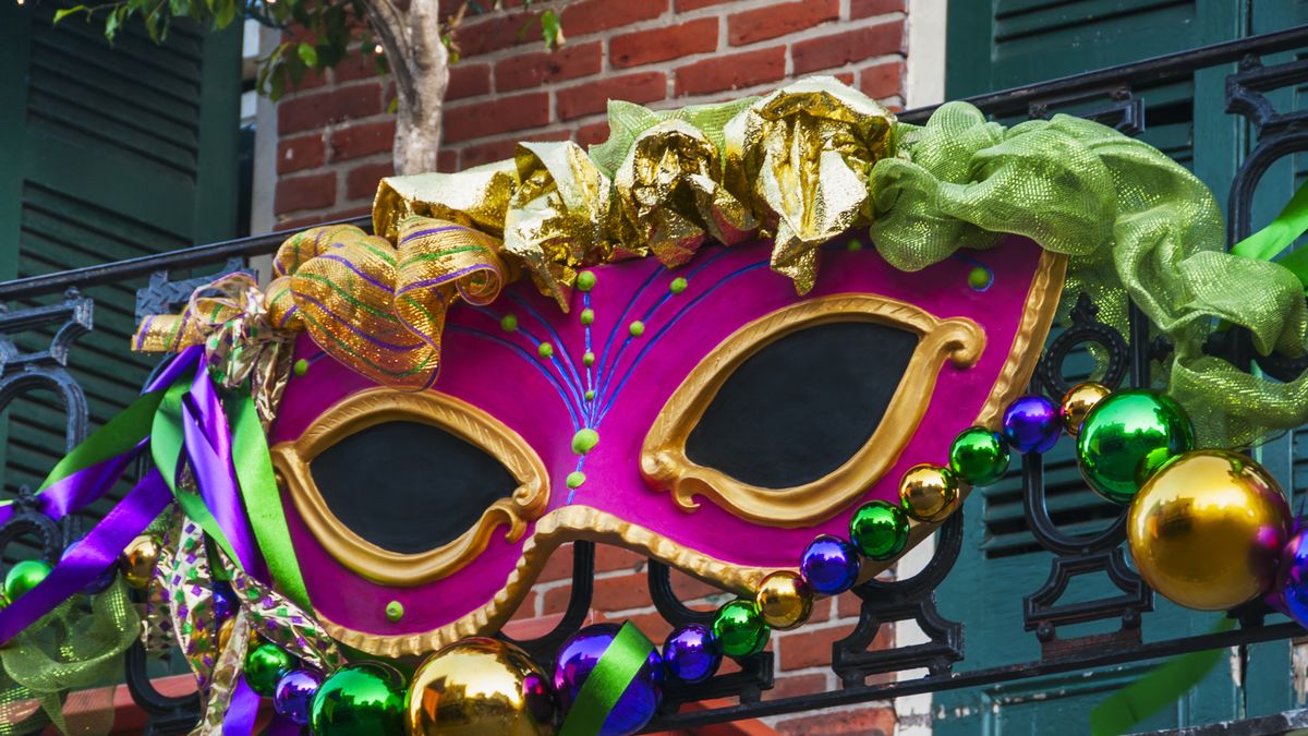 usa, new orleans, louisiana, mardi gras mask hanging on balcony's railing