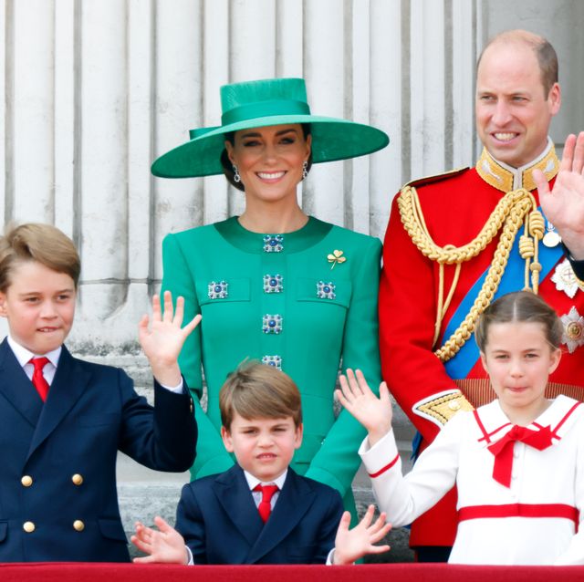 kate middleton prince william and their three children smile and wave from a palace balcony