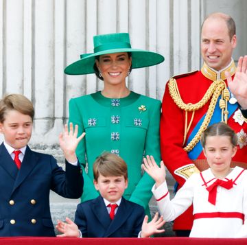 kate middleton prince william and their three children smile and wave from a palace balcony