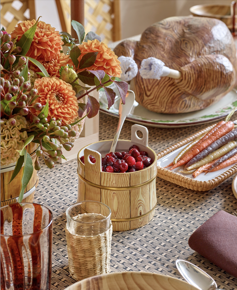 a thanksgiving table set with florals a fake turkey and wooden accents