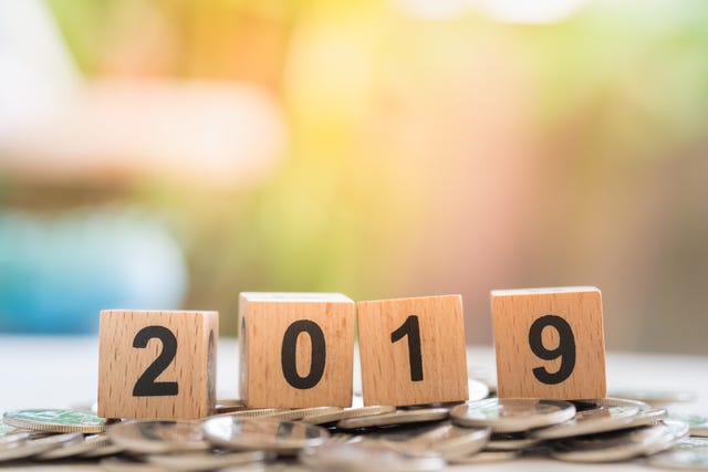 2019 New year, Saving and Business concept. Close up of wooden number blocks on pile of silver coins on