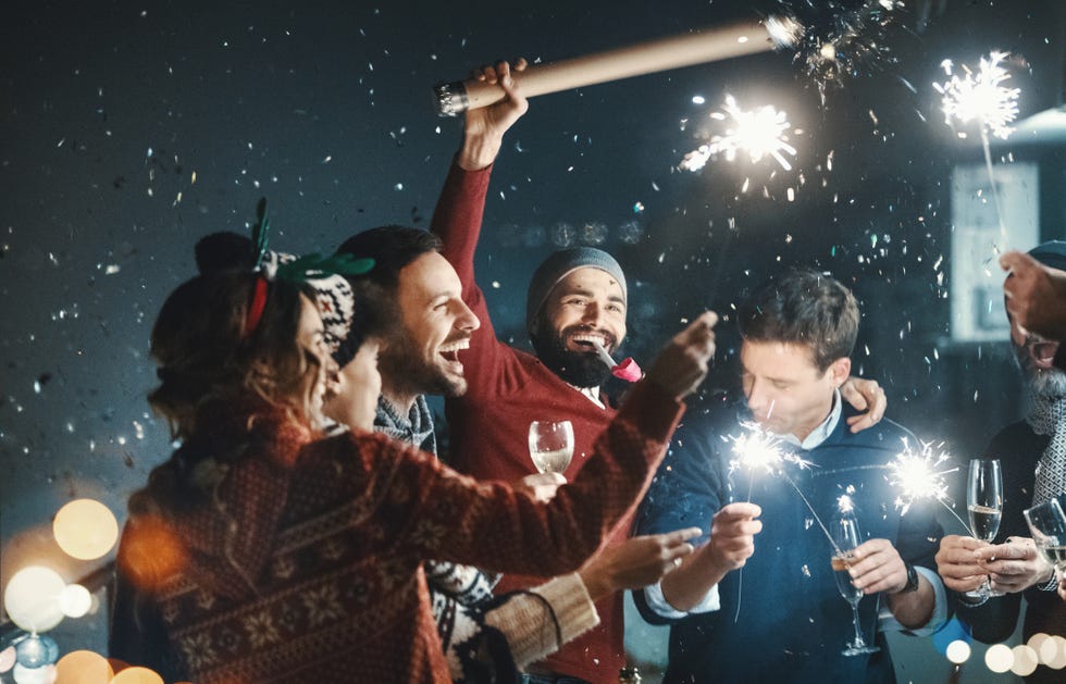 closeup of group of mixed age people having new years party at a building rooftop