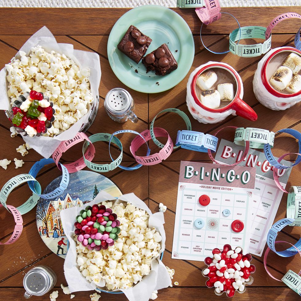 a tabletop filled with popcorn and candy and a movie ticket garland