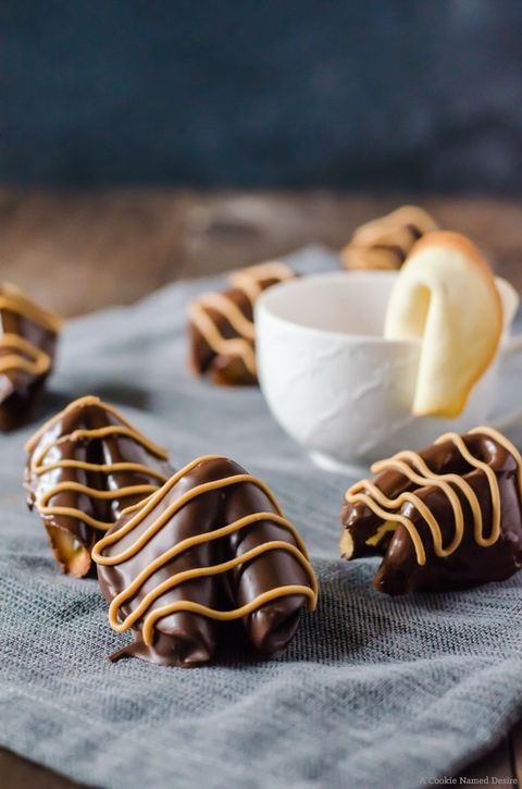 chocolate peanut butter covered fortune cookies on gray linen