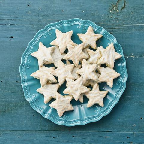 pistachio star cookies on blue plate with blue background