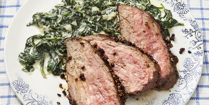 new years eve dinner ideas steak and spinach on blue and white background