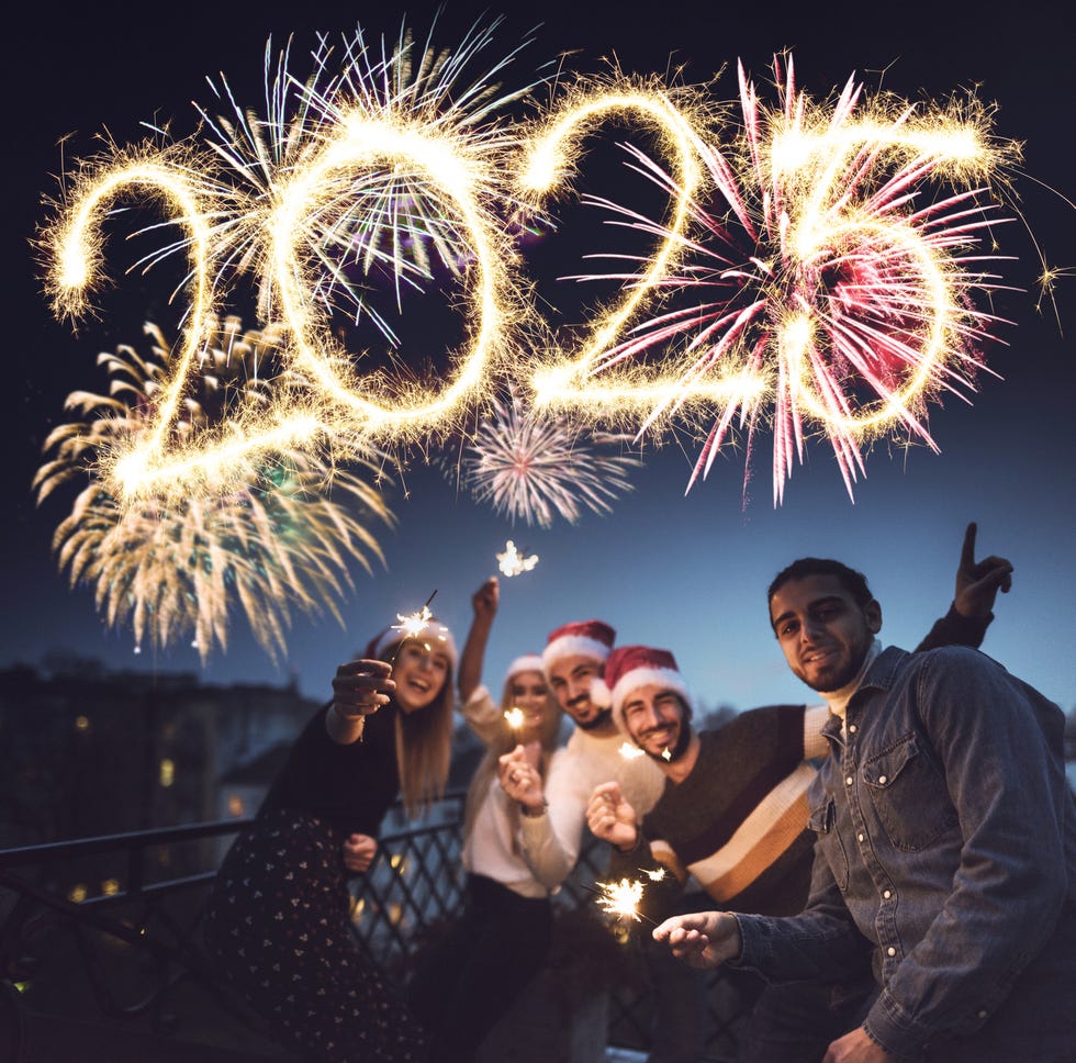 a group of people celebrating new years with the year 2025 written out in sparklers