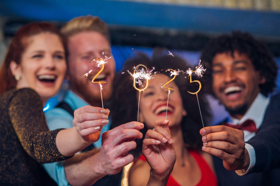 a group of friends celebrating new years with sparklers