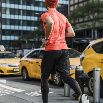 usa, new york city, man running in the city with data on pavement