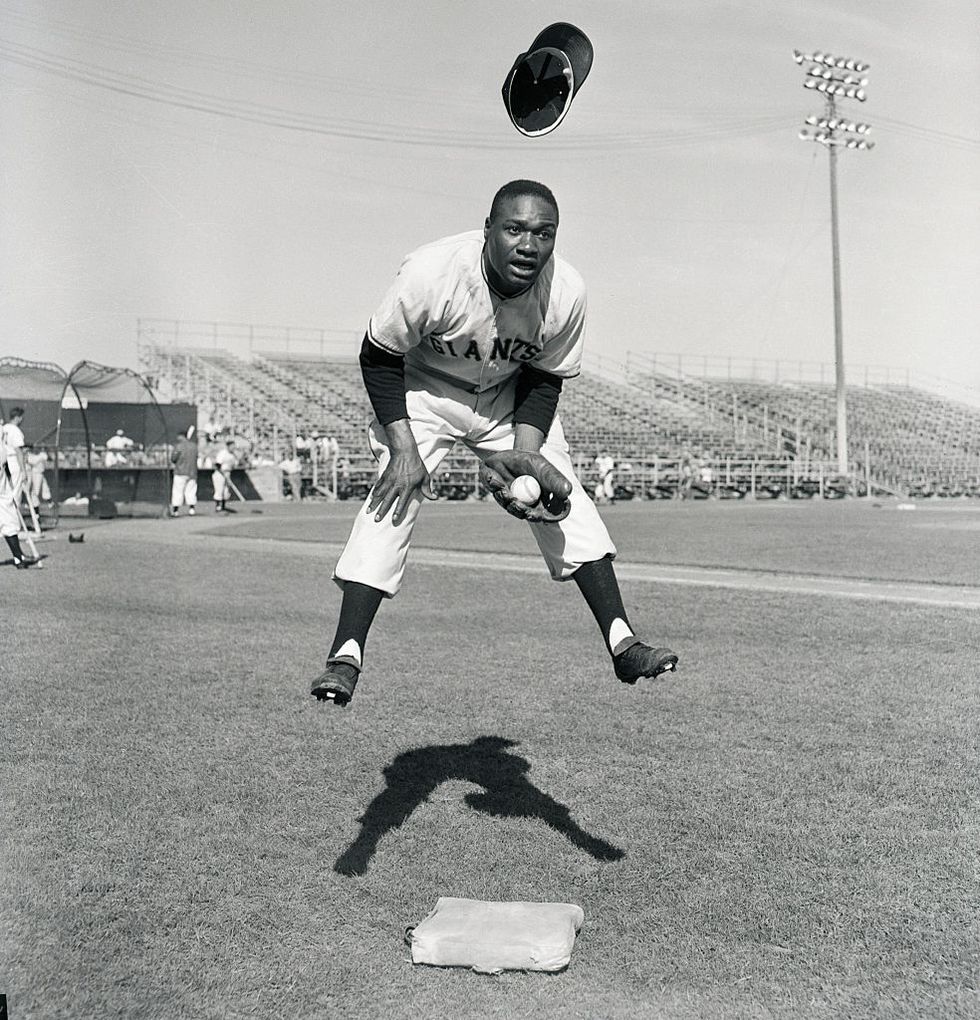 hank thompson leaping to field a ball as his cap flies off