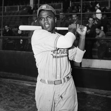 jackie robinson swinging a bat during practice