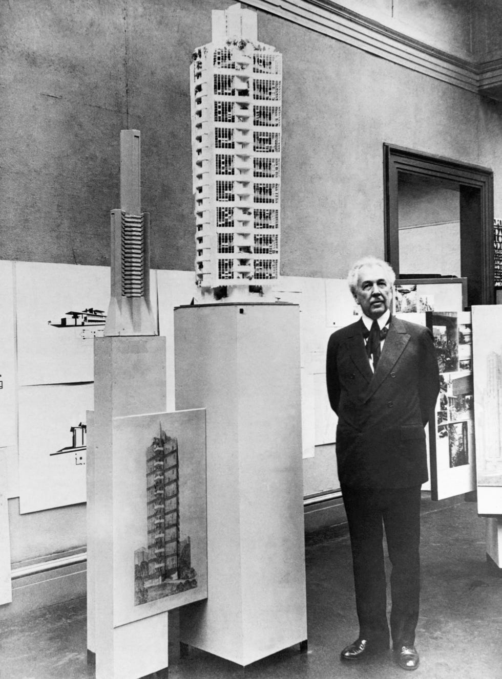 frank lloyd wright standing beside architectural model