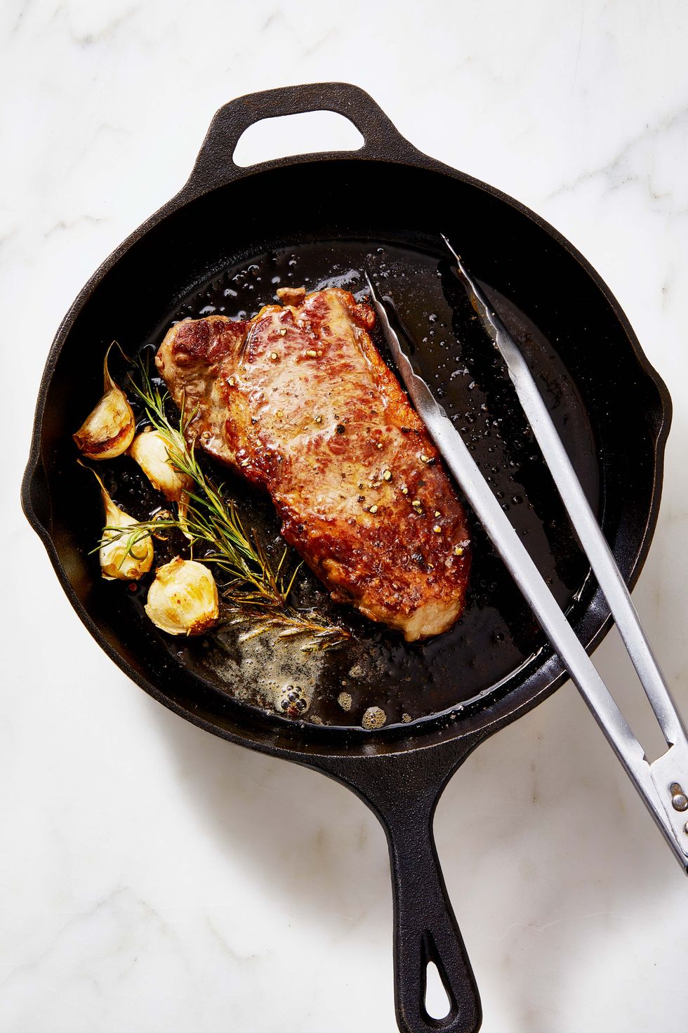 new york strip steak in a cast iron pan