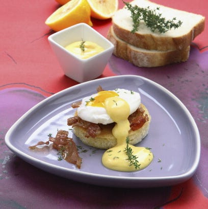 New York-style eggs benedict with bacon new york style eggs benedict with bacon on a plate