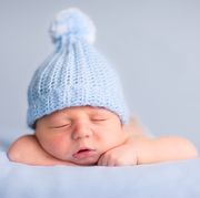 newborn baby boy sleeping peacefully wearing knit hat
